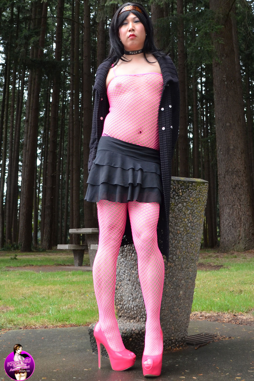 Petite Asian shemale posing outdoors in pink nylon stockings & heels
