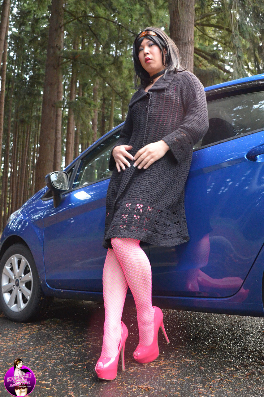 Petite Asian shemale posing outdoors in pink nylon stockings & heels  